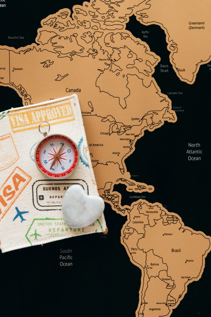 Why Do We Travel? The Real Reasons Behind Our Journeys Flat lay photo of a map, passport, and compass, symbolizing travel and adventure.